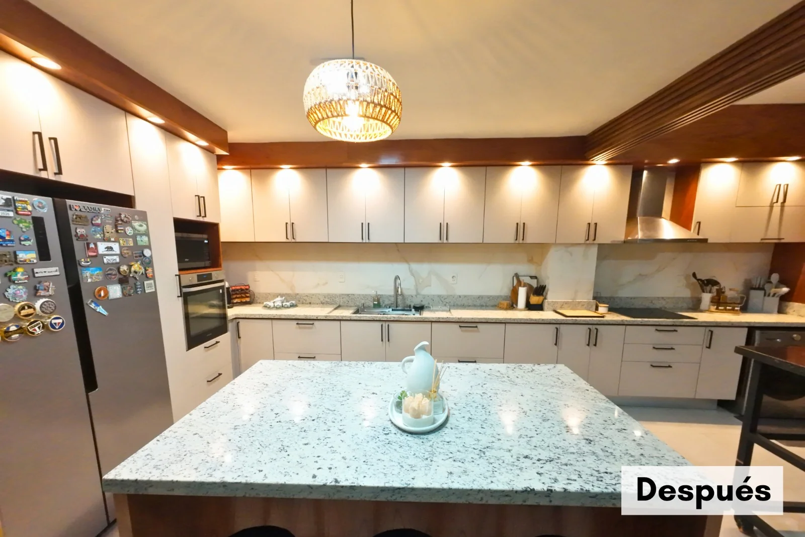 Cocina Edith renovada, con muebles claros, iluminación cálida e isla central
